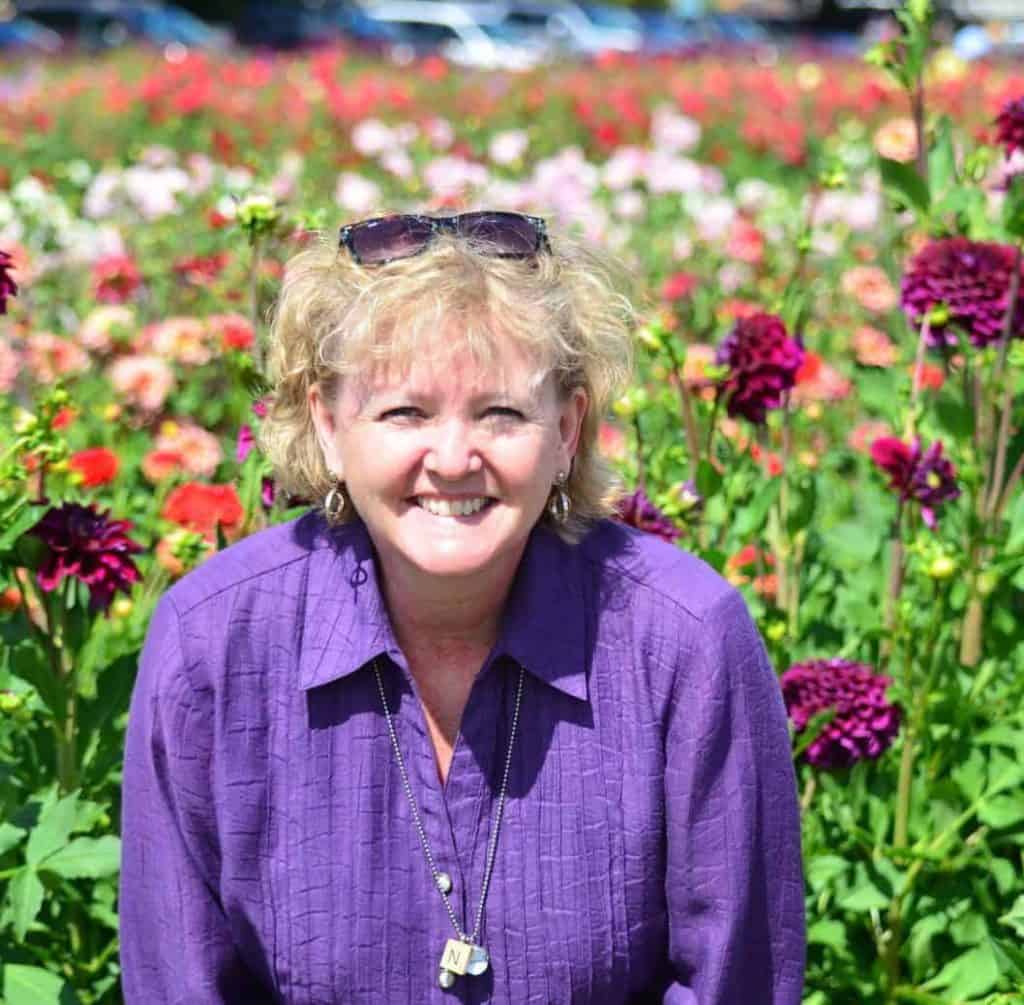 Traveling with Purpose - Educational Travel - Nancy Hann among the Dahlia's