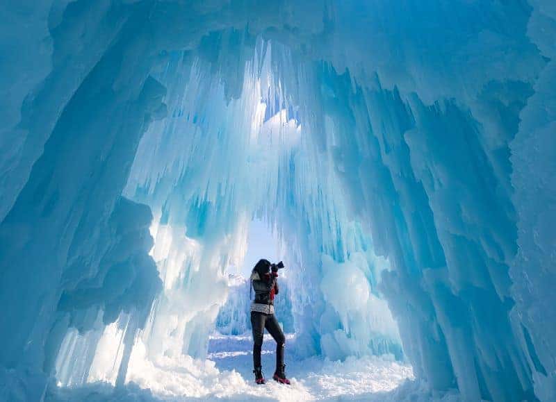 woman photographer in ice cave