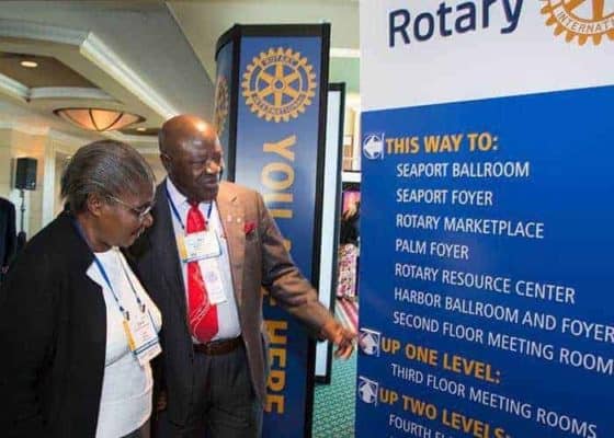 Members of Rotary Club International reading information board