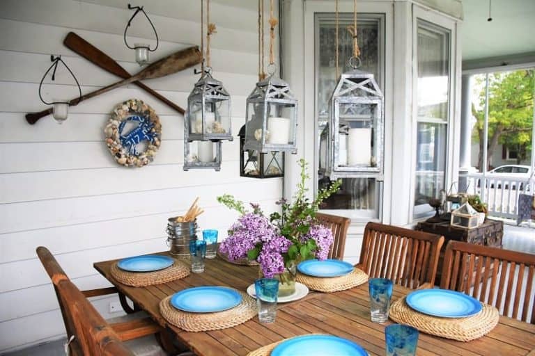 Table on porch set with blue plates and flowers - West Point Historic Garden Home Tour Porch