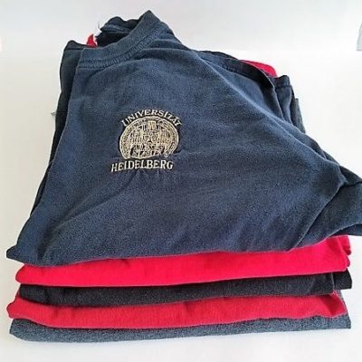 5 folded red and black Tshirts to pack in Gorex Packing Cubes