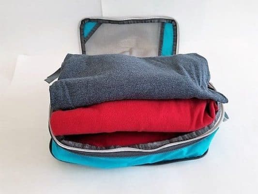 5 T-shirts stacked in an unzipped Medium Size Gorex Packing Cube