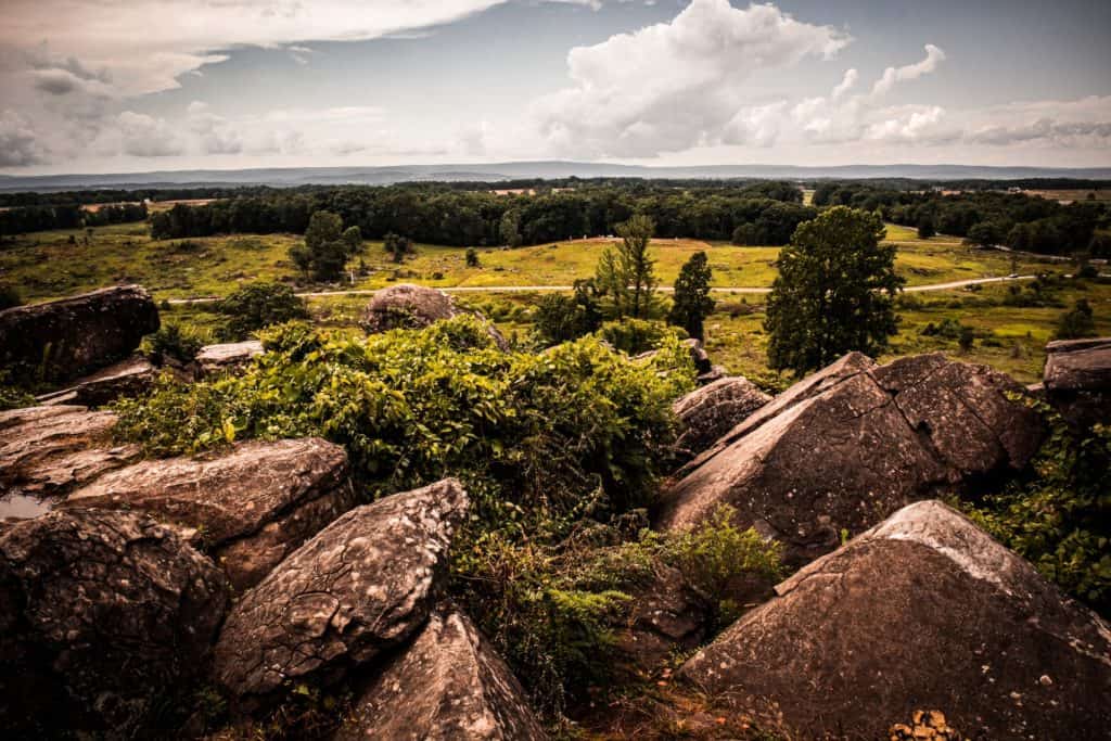 Large boulders with view of grass, road and trees from Little Round Top at Gettysburg National Historical Battlefield in Pennsylvania