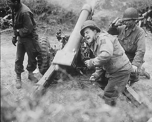 American howitzers shell German forces retreating near Carentan, France.