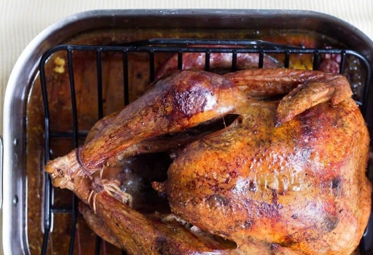 Overhead view of cooked turkey in a roasting pan