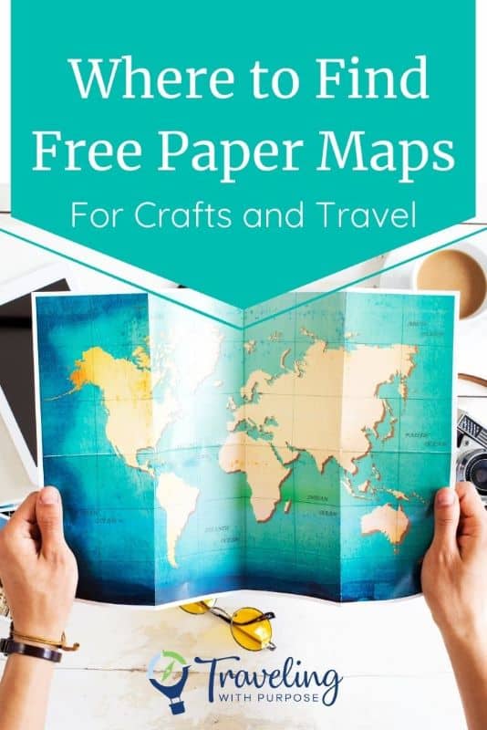 Person holding a paper map with text that says "Where to find free paper maps for crafts and travel?