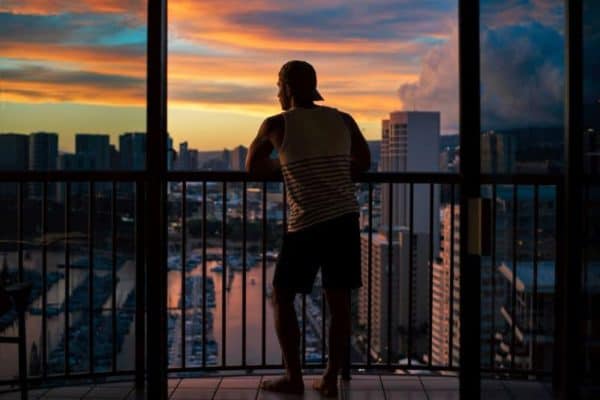 Man enjoying view of the city from balcony