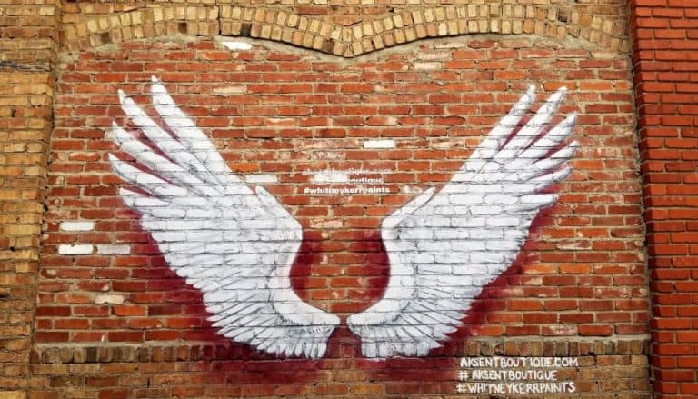 Angel wings mural on a red brick wall in Abilene Kansas