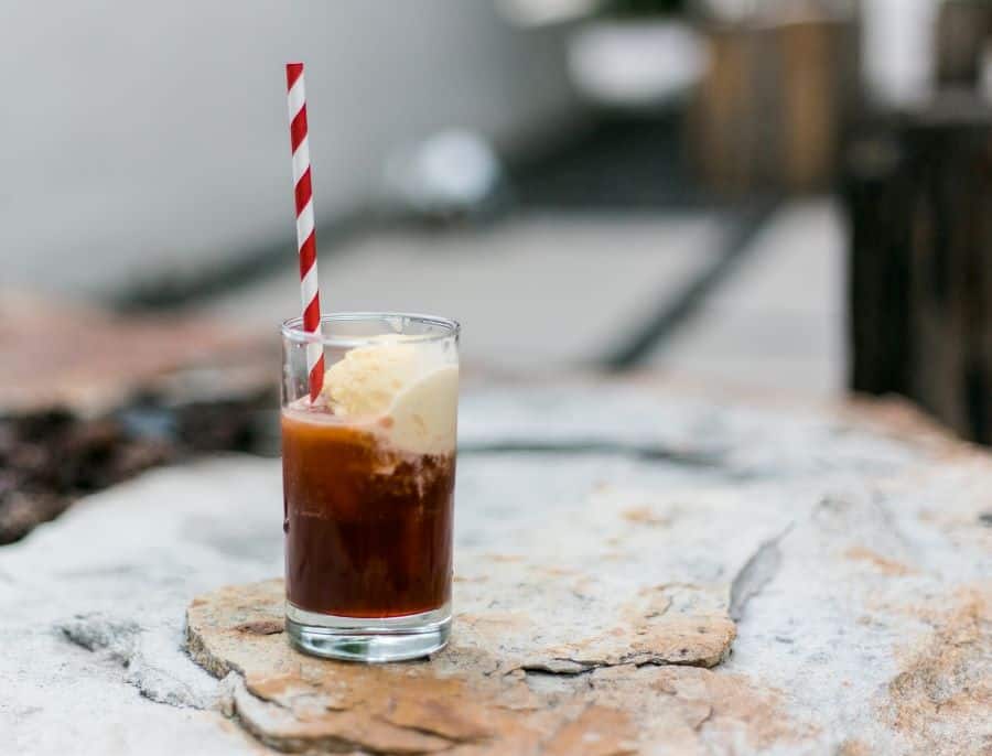 rootbeer float with red and white paper straw