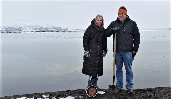 Man and woman geothermal baking in Iceland