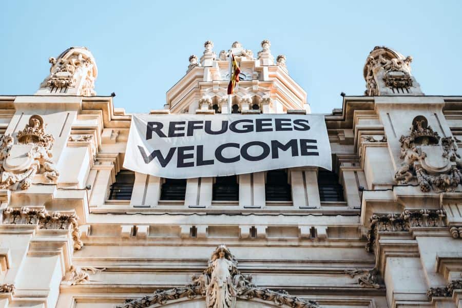 large "Refugees Welcome" sign hanging on building