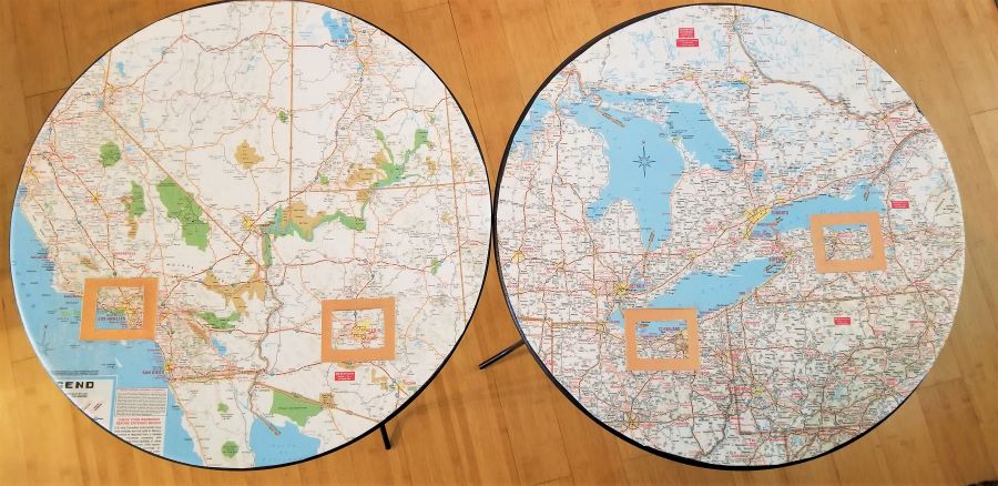 Two round tables with maps glued to tabletops