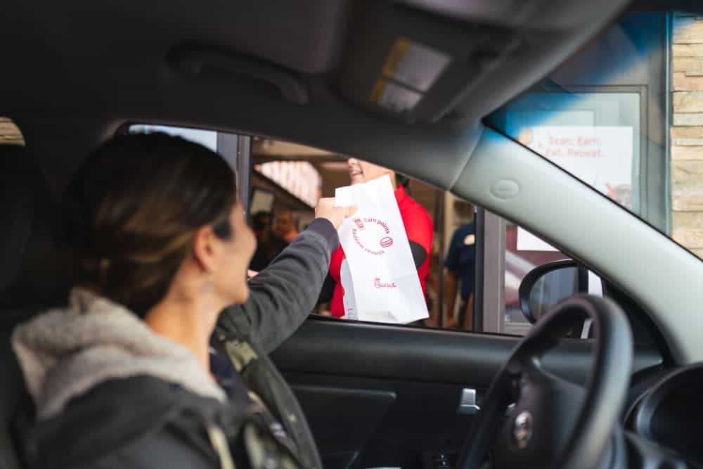 Person getting food from fast food drive through