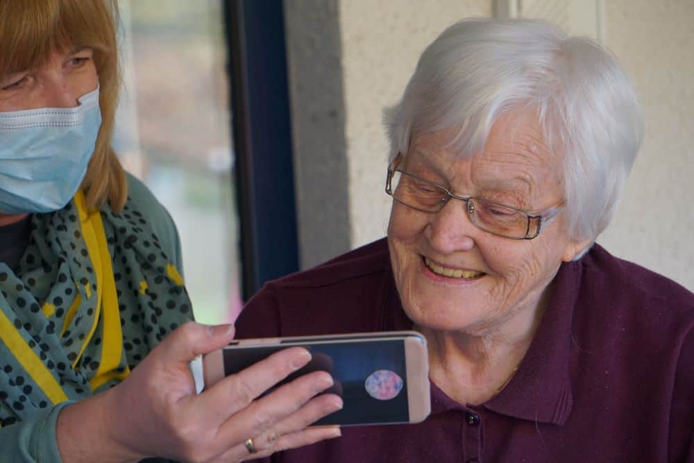 Two women watching video on smartphone