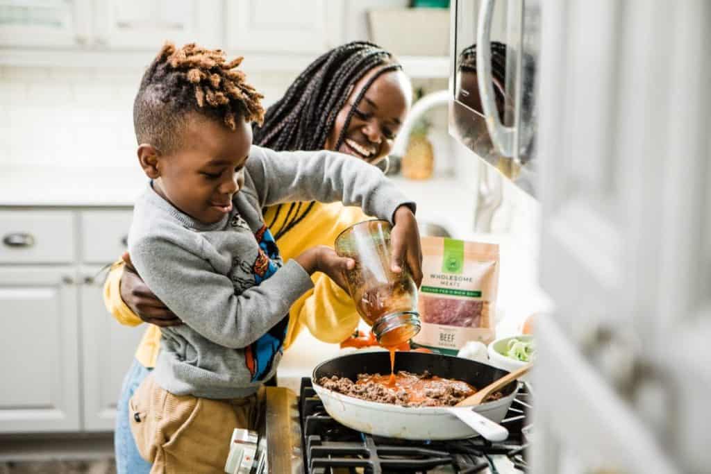 African American woman with boy cooking a meal together