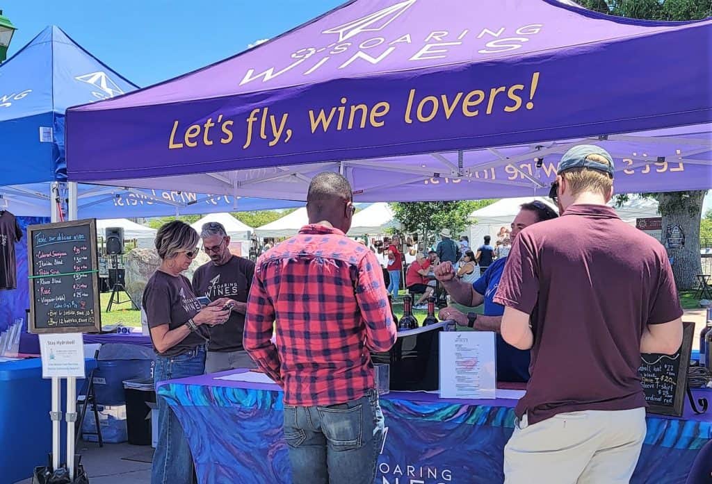 Two men tasting wine at the Soaring Wines tent at Willcox Wine Festival