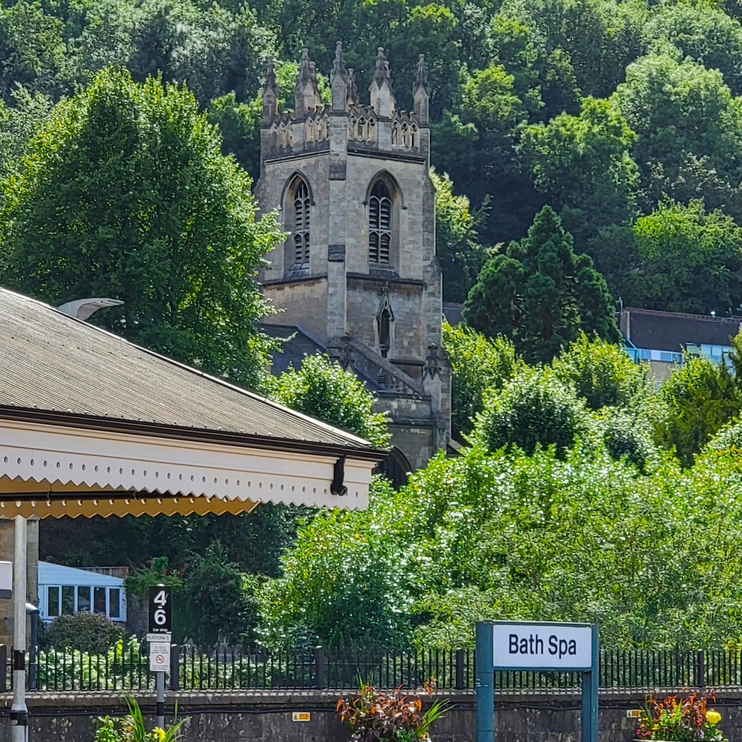 View of trees and church tower from Bath Spa England Train Station