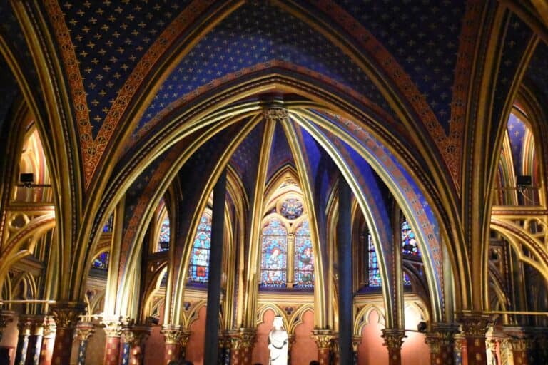 Gorgeous blue ceilings with gold arches inside the St. Chappelle Cathedral in Paris France