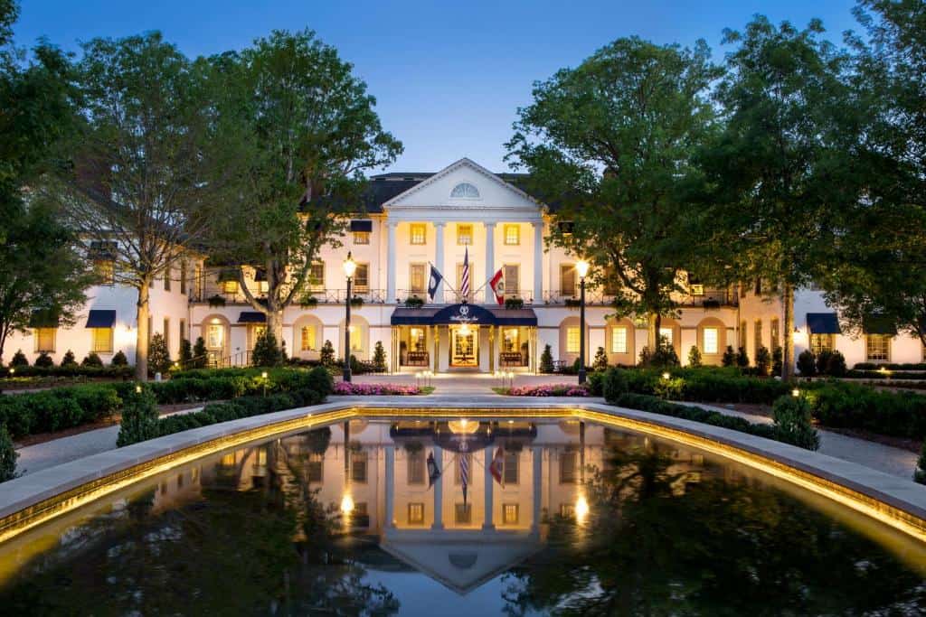 Beautiful white luxury hotel at night with a reflecting pond in front.
Williamsburg Inn, Virginia