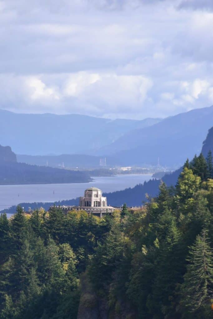 A historical octagonal stone building perched on a cliff overlooking the Columbia River. Vista House - Crown Point State Scenic Corridor - Columbia River Gorge, Oregon