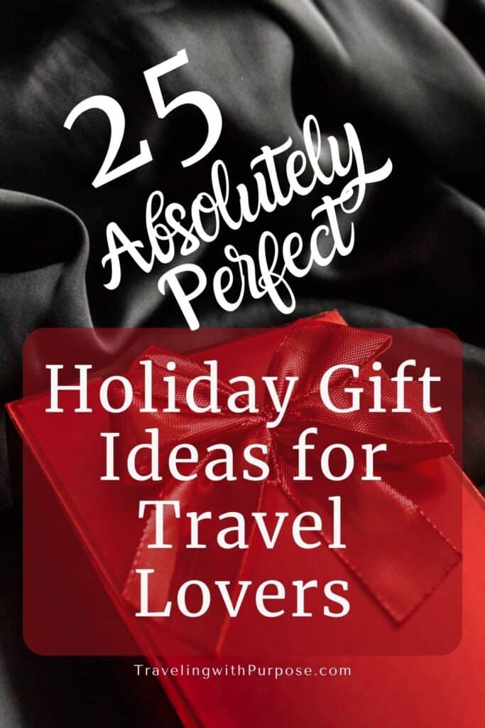 A red wrapped gift on a black satin fabric background with the words "25 Absolutely Perfect Holiday Gift Ideas for Travel Lovers"