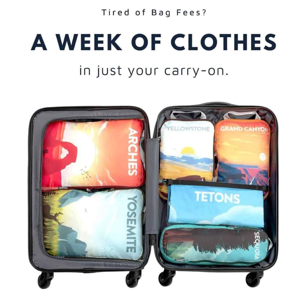 Carry-on suitcase with 6 different compression packing cubes inside. Each with a different national park design on the outside.