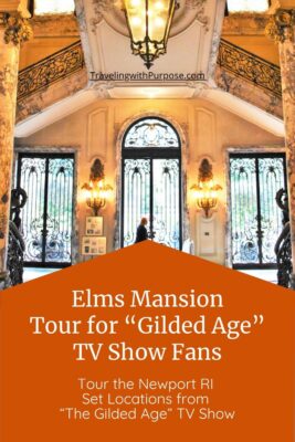 A person stands at the massive glass door decorated with black wrought iron. The marble floors and pillars fill the Interior front entrance at The Elms mansion in Newport, Rhode Island.