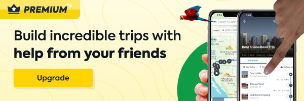 Graphic showing 2 hands holding a cell phone with a Roadtrippers app map on the screen. Text on a yellow background says "Roadtrippers Premium.  Build incredible trips with help from your friends."
